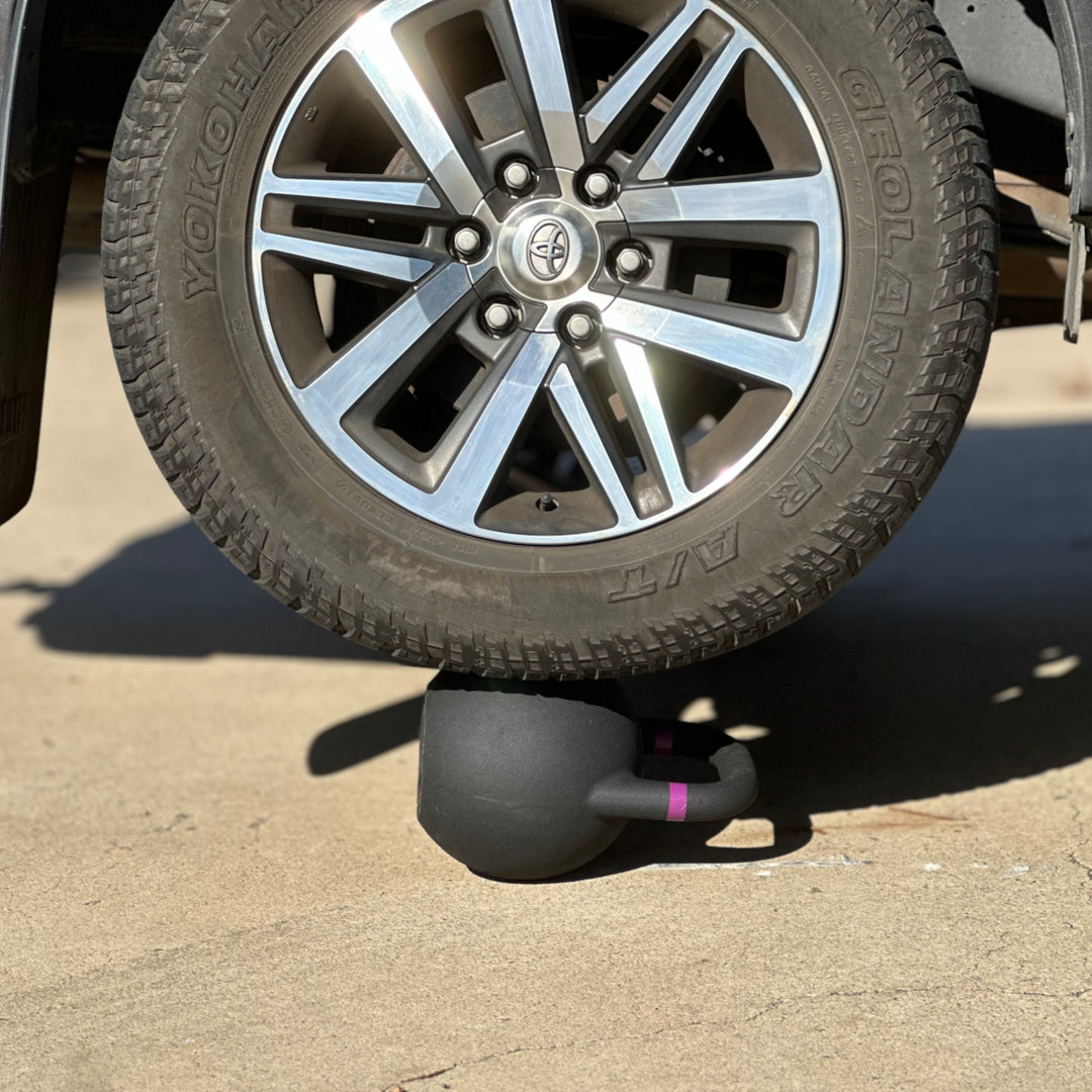 SIEGE matte black powder coat cast iron competition kettlebell driven over during ute structural quality test